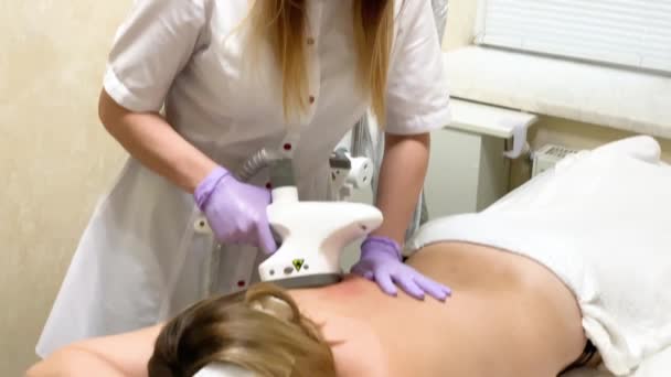 Hautpflege. Kosmetologe macht eine Frau lpg Massage auf dem Rücken — Stockvideo
