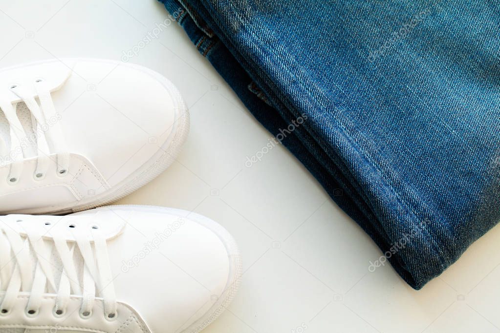 Jeans and sneakers on the store shelf.