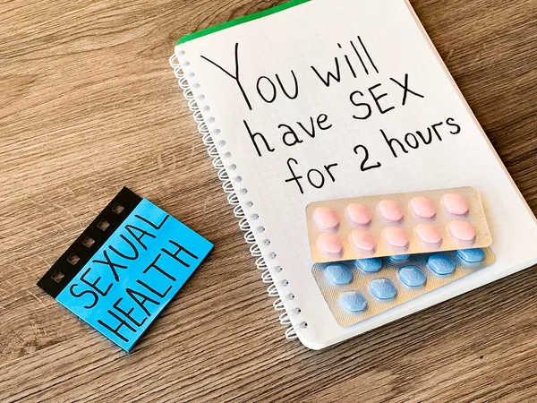 Pills for mens sexual health and notepad with text. — Stock Photo, Image
