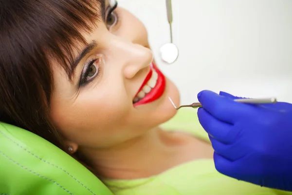 Dental care. Woman treats teeth in dental clinic.