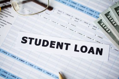 Credit concept. Student loan written on white card. clipart