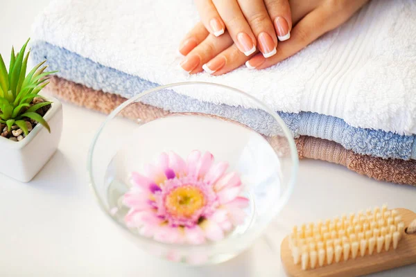 Nails care. Beautiful womans nails with french manicure, in beauty studio