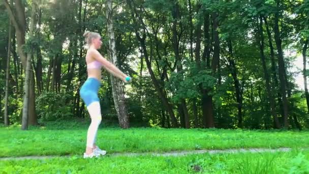 Γυμναστήριο γυναίκα κάνοντας άσκηση σε πράσινο γκαζόν. — Αρχείο Βίντεο