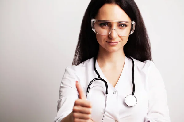 Portrait of a doctor with glasses and a white medical gown looking at the camera — Stock Photo, Image