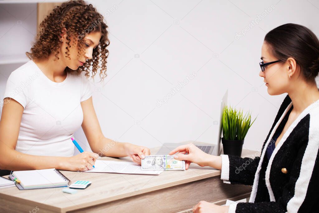 Bribery concept, a woman gives a bribe to an employee of the company for signing a contract