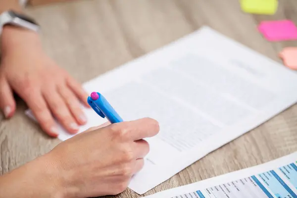 Business woman signs a contract in the office at the table — Stock Photo, Image