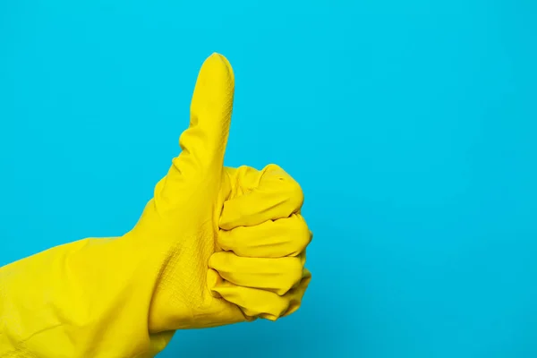 Hand in a yellow glove for cleaning