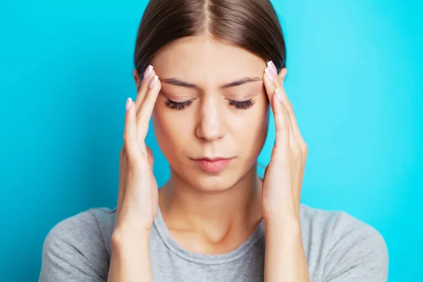 Head pain, exhausted young woman has suffering from unbearable headache