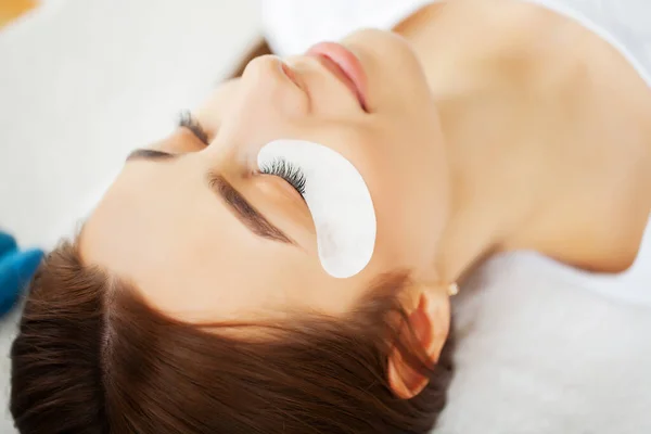 Young woman in a beauty studio on an eyelash extension procedure — Stock Photo, Image