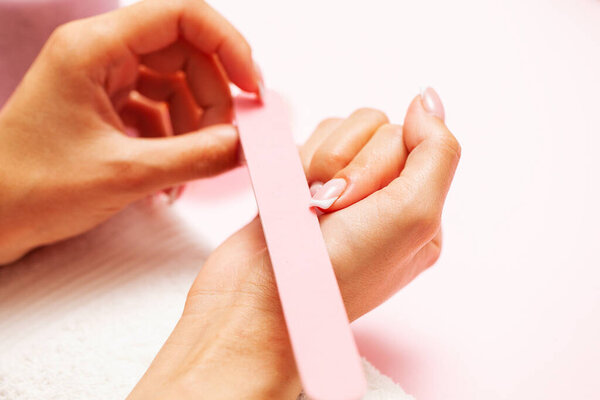 Woman close up of doing manicure on hands