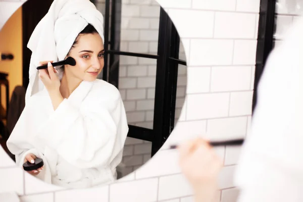 Hermosa mujer usando cepillo para el maquillaje diario en el baño — Foto de Stock