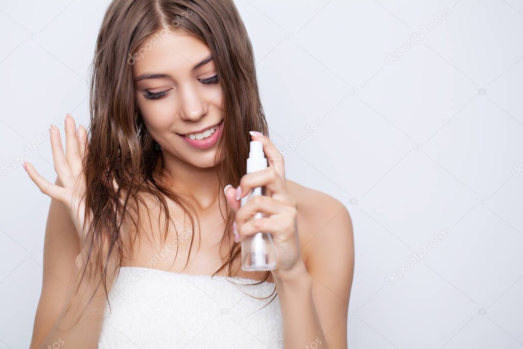 Young woman takes care of her hair using natural oils and conditioners for hair care