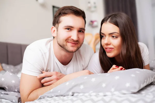 Happy couple having fun in bed. Intimate sensual young couple in bedroom enjoying each other — Stock Photo, Image