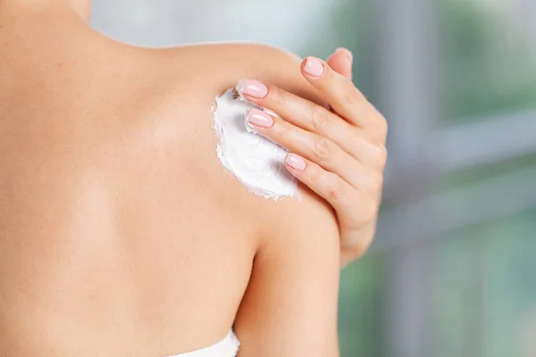 Skin care, woman wears moisturizer on skin Stock Picture
