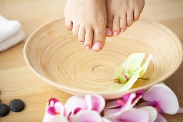 Closeup photo of a female feet at spa salon on pedicure procedure — Stock Photo, Image