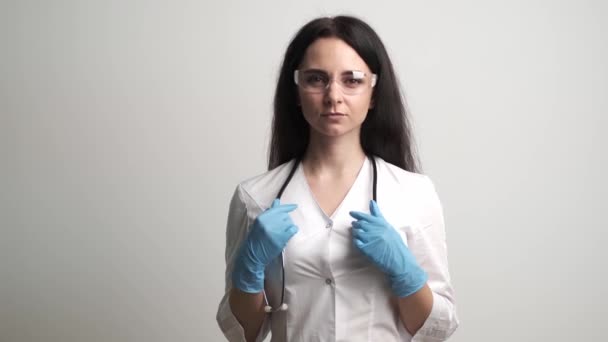 Doctor in a white coat posing at the camera — Stock Video