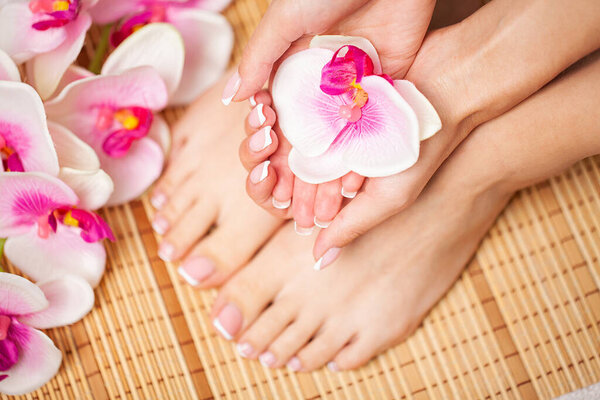 The picture of female legs and hands after pedicure and manicure