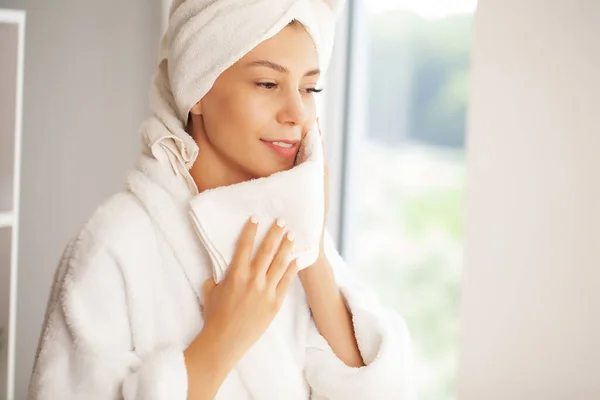 Жінка чистить шкіру обличчя рушником після миття портрета обличчя — стокове фото