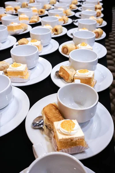 Empty coffee cups and bakery catering for coffee break.
