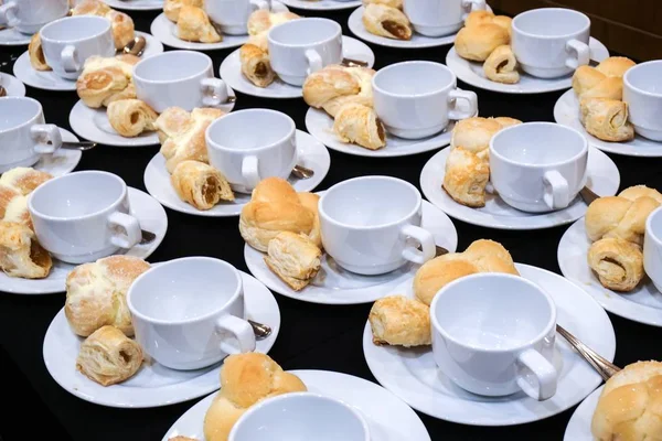 Empty coffee cups and bakery catering for coffee break.