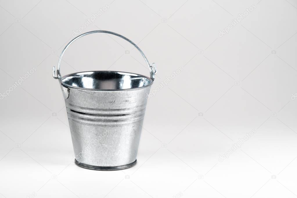 Small galvanized bucket on white background. 