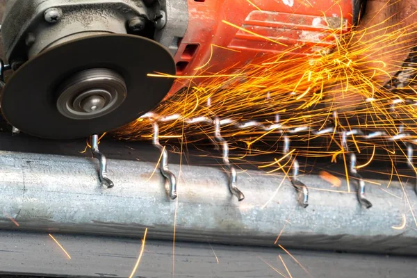 Man gebruikt Haakse slijper zonder deksel Guard snijden metalen net te maken vogelkooi. — Stockfoto