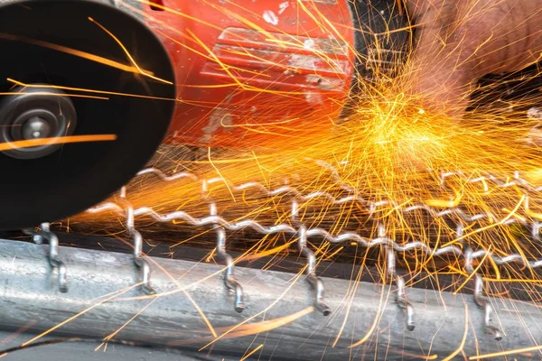 man used angle grinder without cover guard cutting metal net to make bird cage.