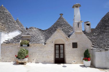 Trullo, İtalya 'nın Alberobello kentindeki Rione Aia Piccola caddesinde. Alberobello İtalya 'nın güneyinde küçük bir kasabadır. Trullo, konik çatısı olan geleneksel bir Apulian kuru taş kulübesi..