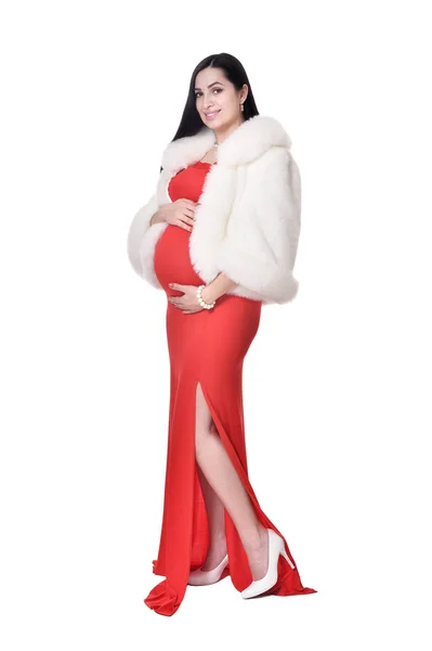 ポーズの分離の白い背景の赤いドレスに妊娠中の女性 — ストック写真