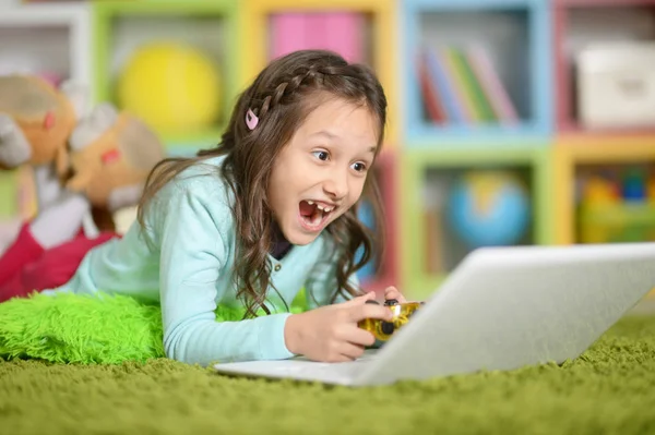 Cute Girl Playing Computer Game Laptop While Lying Floor Home — Stock Photo, Image