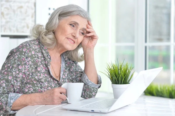 Emotional senior woman with laptop — Stock Photo, Image