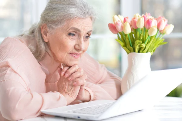 Femme âgée émotionnelle avec ordinateur portable — Photo
