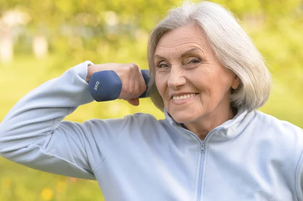 Mature woman with dumbbell — Stock Photo, Image