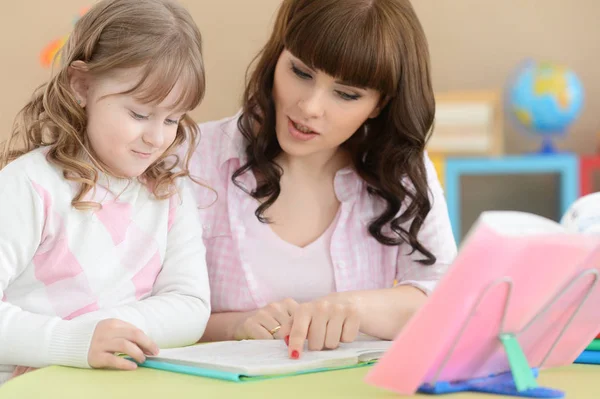 Mother with daughter doing homework — Stock Photo, Image
