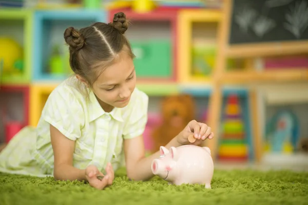 Beautiful girl with a piggy bank — Stock Photo, Image