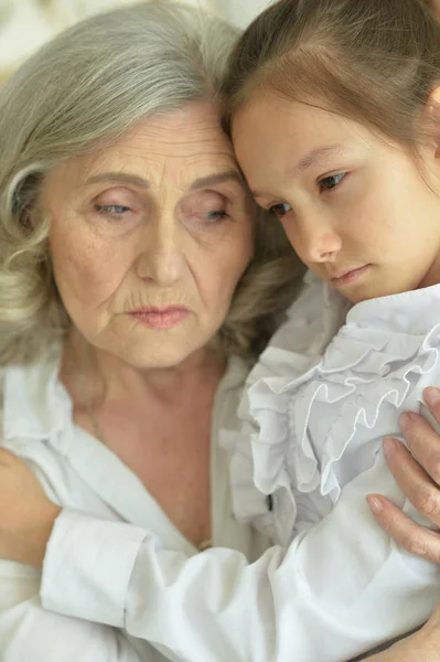 Portret Van Triest Oma Kleindochter Knuffelen Thuis — Stockfoto