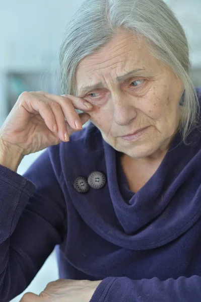 close-up portrait of a sad elderly woman crying