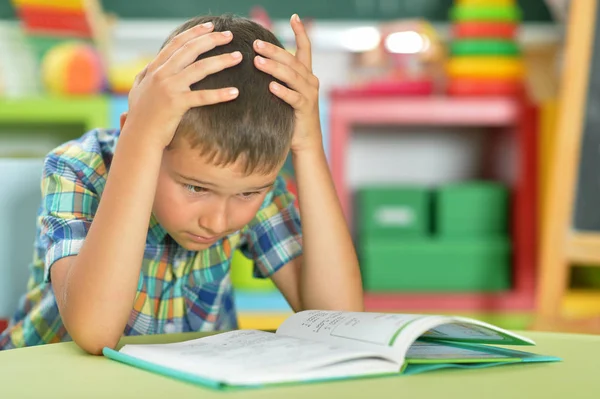 Tired Boy Reading Book Classroom — Stock Photo, Image