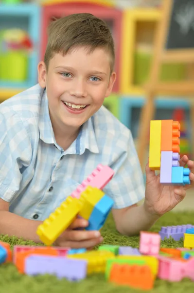 Úsměvem Chlapce Hrát Barevnými Plastovými Bloky Podlaze — Stock fotografie