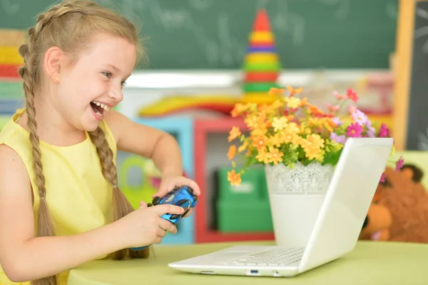 Little girl using modern laptop — Stock Photo, Image