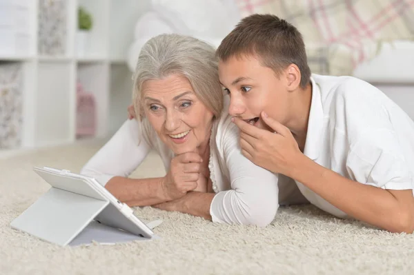 Menina com avó usando tablet — Fotografia de Stock