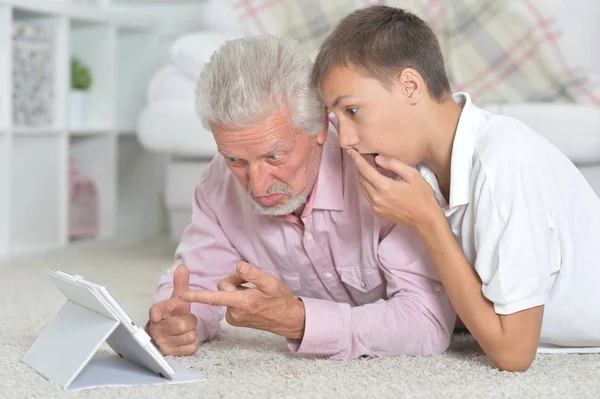 Grandfather Grandson Using Tablet While Lying Floor Home — Stock Photo, Image