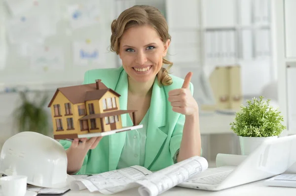 Portrait Young Female Architect Holding Model House Showing Thumb Office — Stock Photo, Image