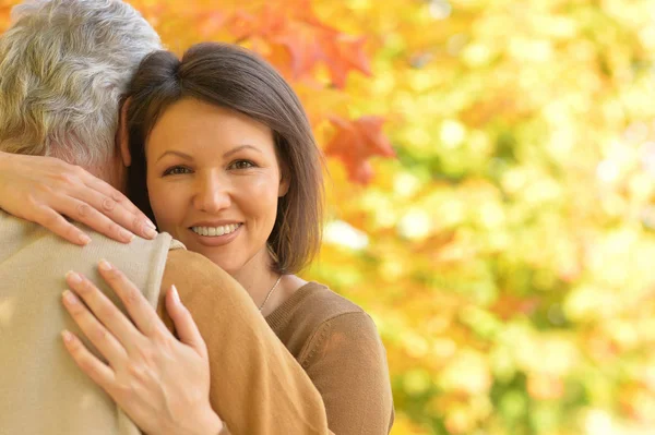 Woman and senior man hugging — Stock Photo, Image