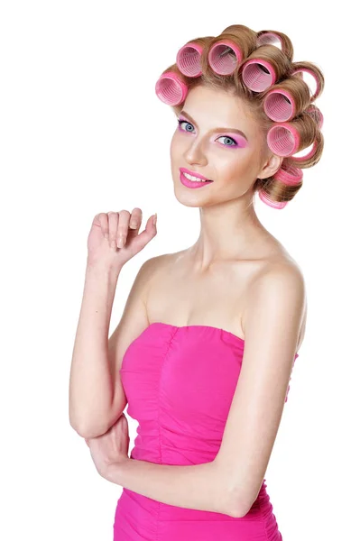 Woman in pink dress with hair curlers — Stock Photo, Image