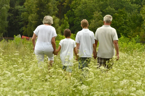 Older man and woman with their grandchildren — Stock Photo, Image