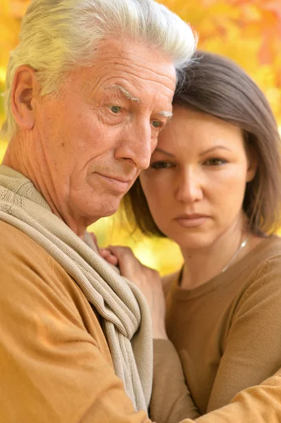 Sad woman and senior man hugging — Stock Photo, Image
