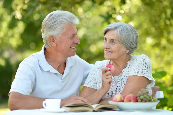 Old couple with book — Stock Photo, Image