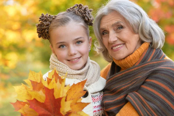 Oma en kleindochter poseren buitenshuis — Stockfoto