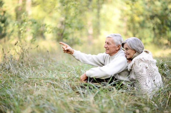 Happy Senior Couple Autumn Park Man Pointing Finger — Stock Photo, Image